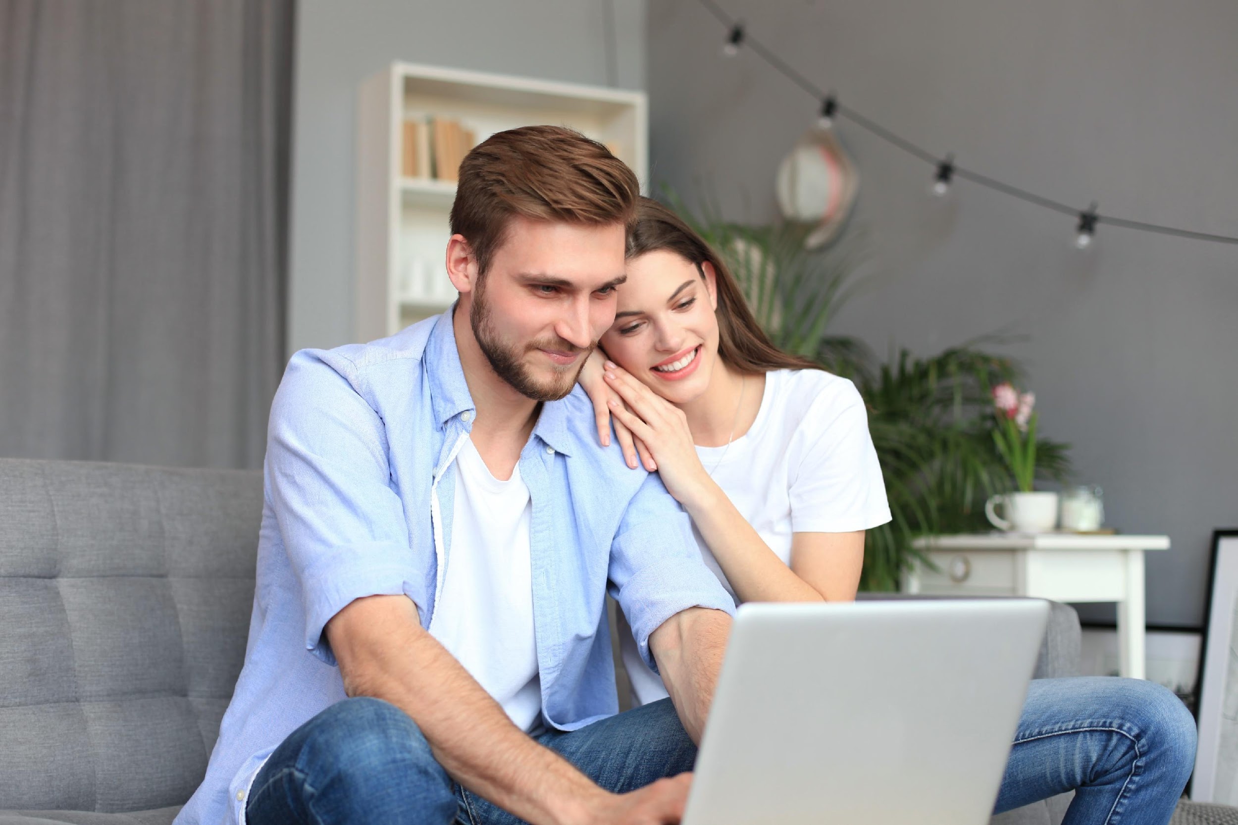 Generic white couple looking at laptop