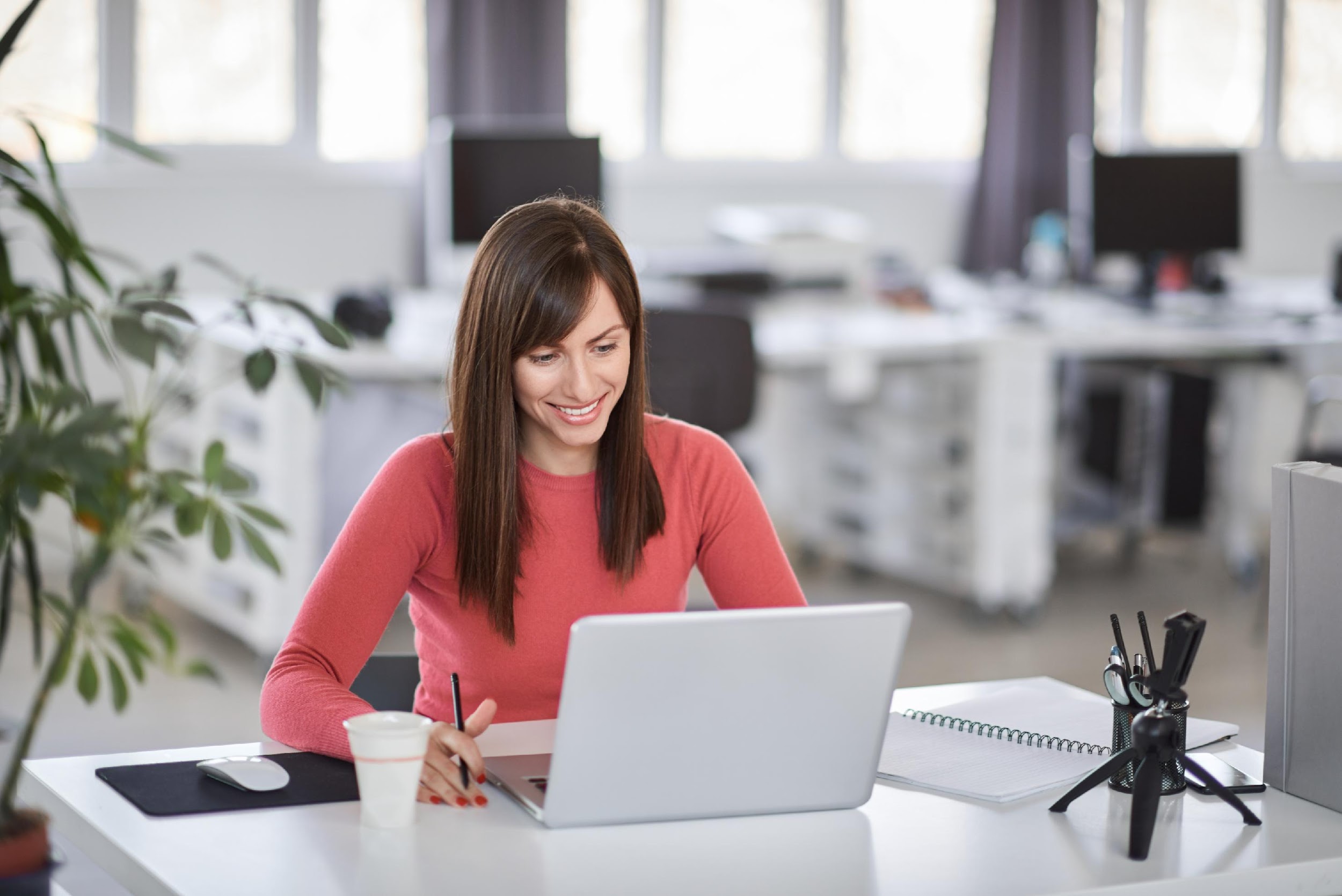 smiling white woman working on a laptop
